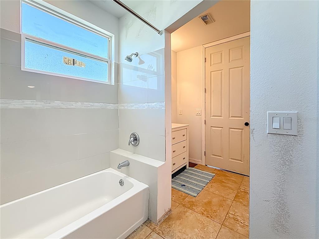 2372 18th Avenue Southwest Largo, FL 33774 - Photo 58 of 80 a bathroom with a tub a sink and a shower