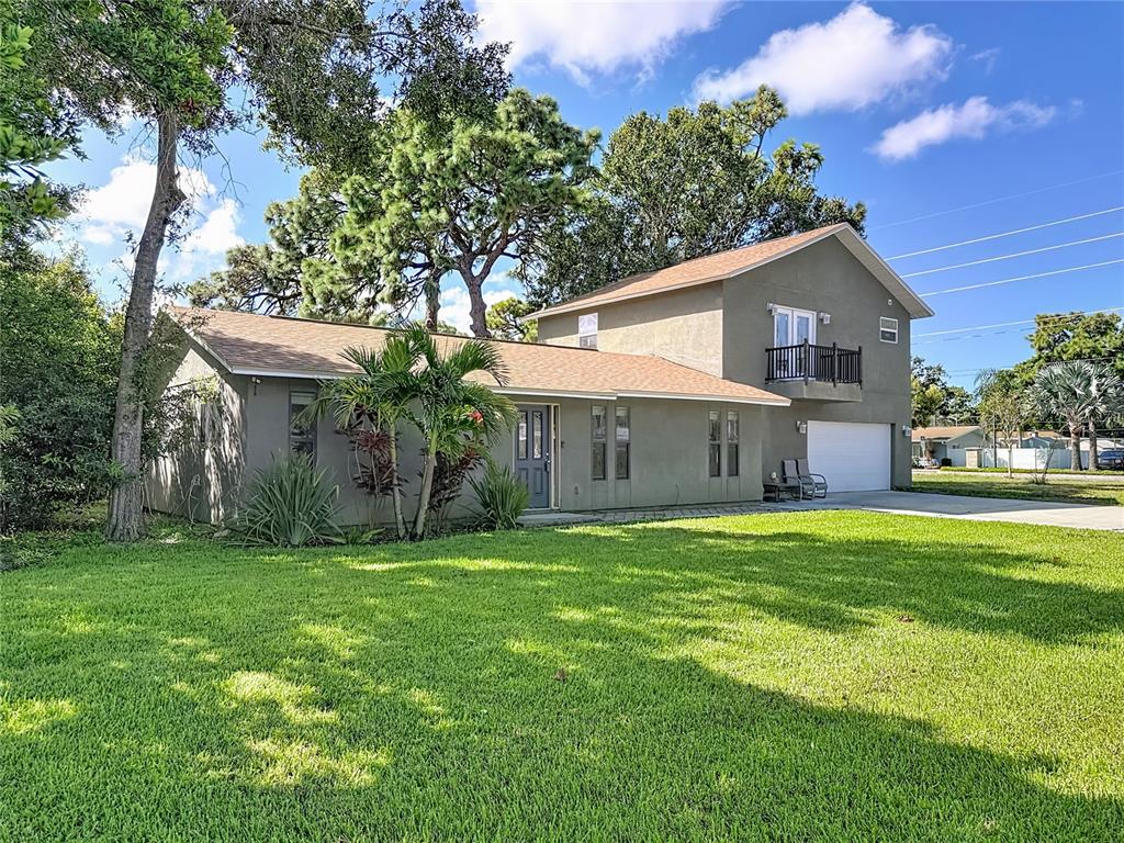 2372 18th Avenue Southwest Largo, FL 33774 - Photo 78 of 80 a front view of a house with a yard and garage