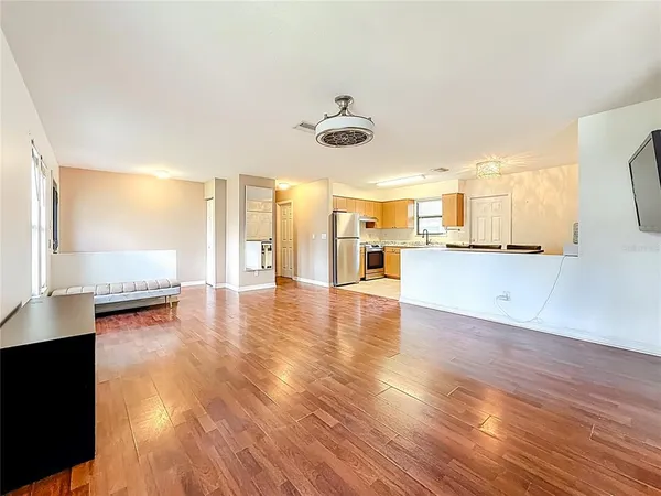 a bedroom with bed window and flat screen tv