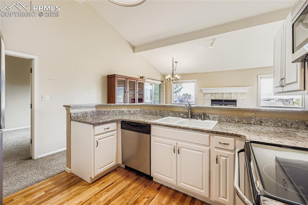 368 Mission Hill Way Colorado Springs, CO 80921 - Photo 11 of 39 a kitchen with granite countertop a sink stove and cabinets