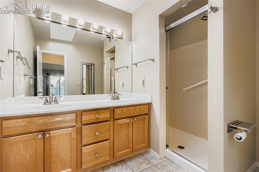 368 Mission Hill Way Colorado Springs, CO 80921 - Photo 19 of 39 a bathroom with a granite countertop sink mirror and double