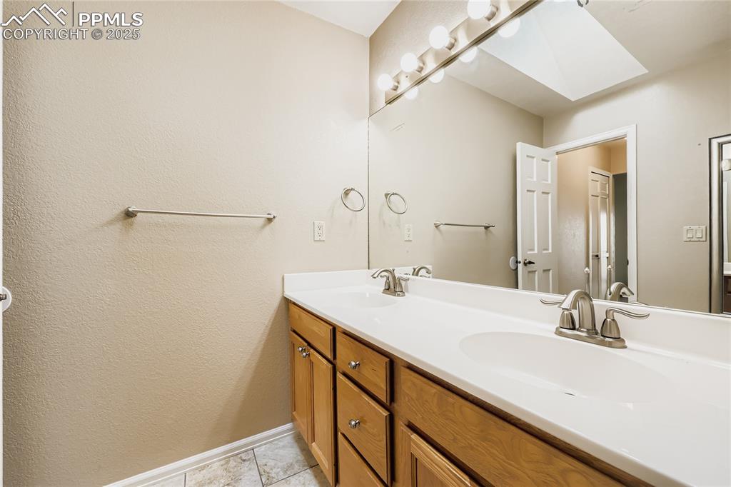 368 Mission Hill Way Colorado Springs, CO 80921 - Photo 20 of 39 a bathroom with a sink and a mirror