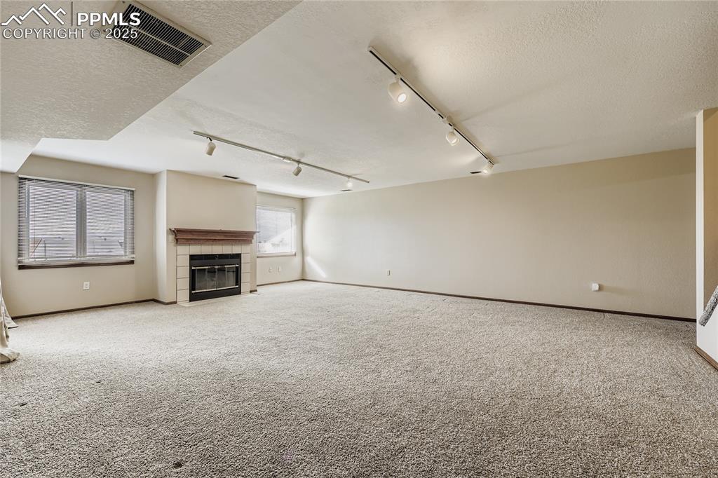 368 Mission Hill Way Colorado Springs, CO 80921 - Photo 25 of 39 an empty room with furniture and a fireplace