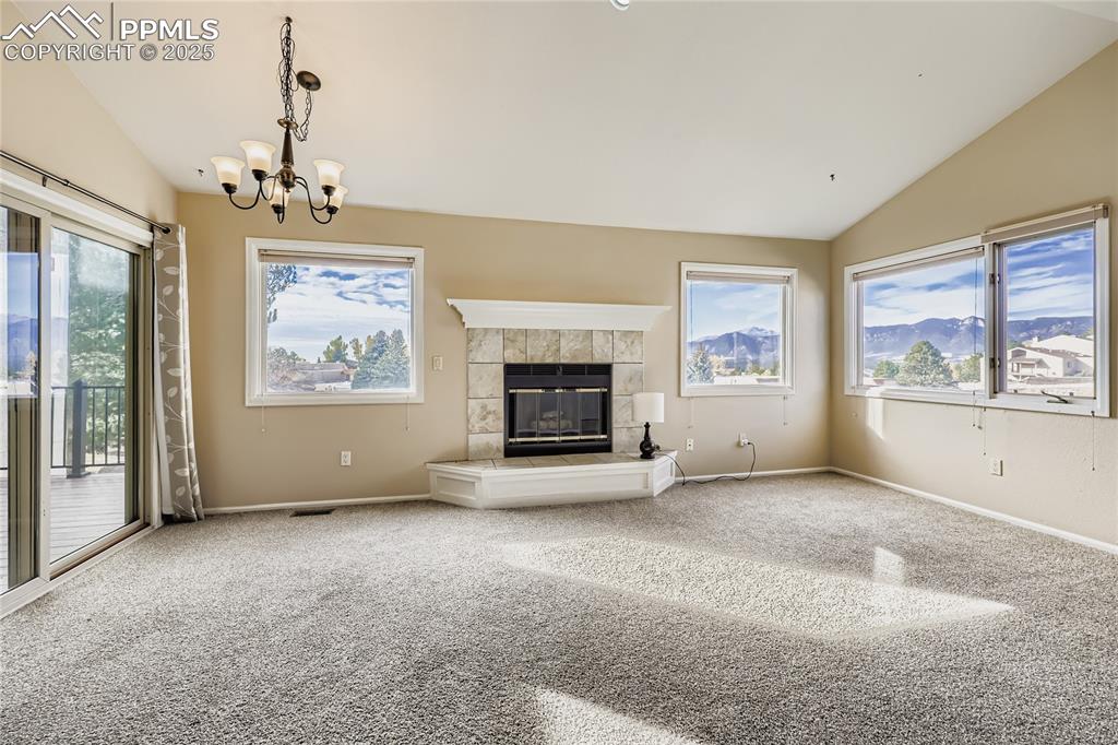 368 Mission Hill Way Colorado Springs, CO 80921 - Photo 6 of 39 wooden floor fireplace and windows in an empty room