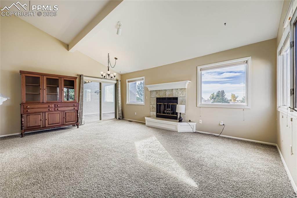 368 Mission Hill Way Colorado Springs, CO 80921 - Photo 7 of 39 an empty room with windows and fireplace