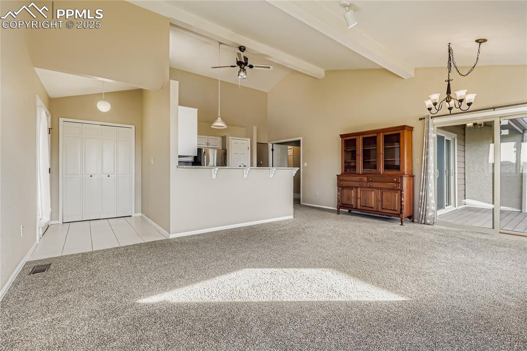 368 Mission Hill Way Colorado Springs, CO 80921 - Photo 8 of 39 an empty room with chandelier fan and windows