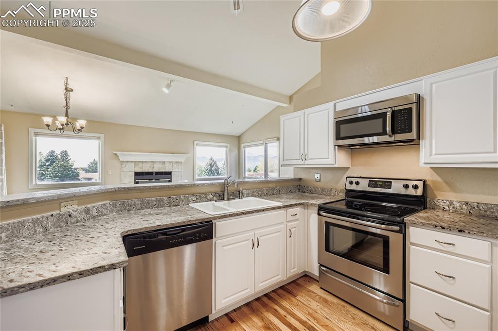 368 Mission Hill Way Colorado Springs, CO 80921 - Photo 10 of 39 a kitchen with granite countertop a sink and stove top oven