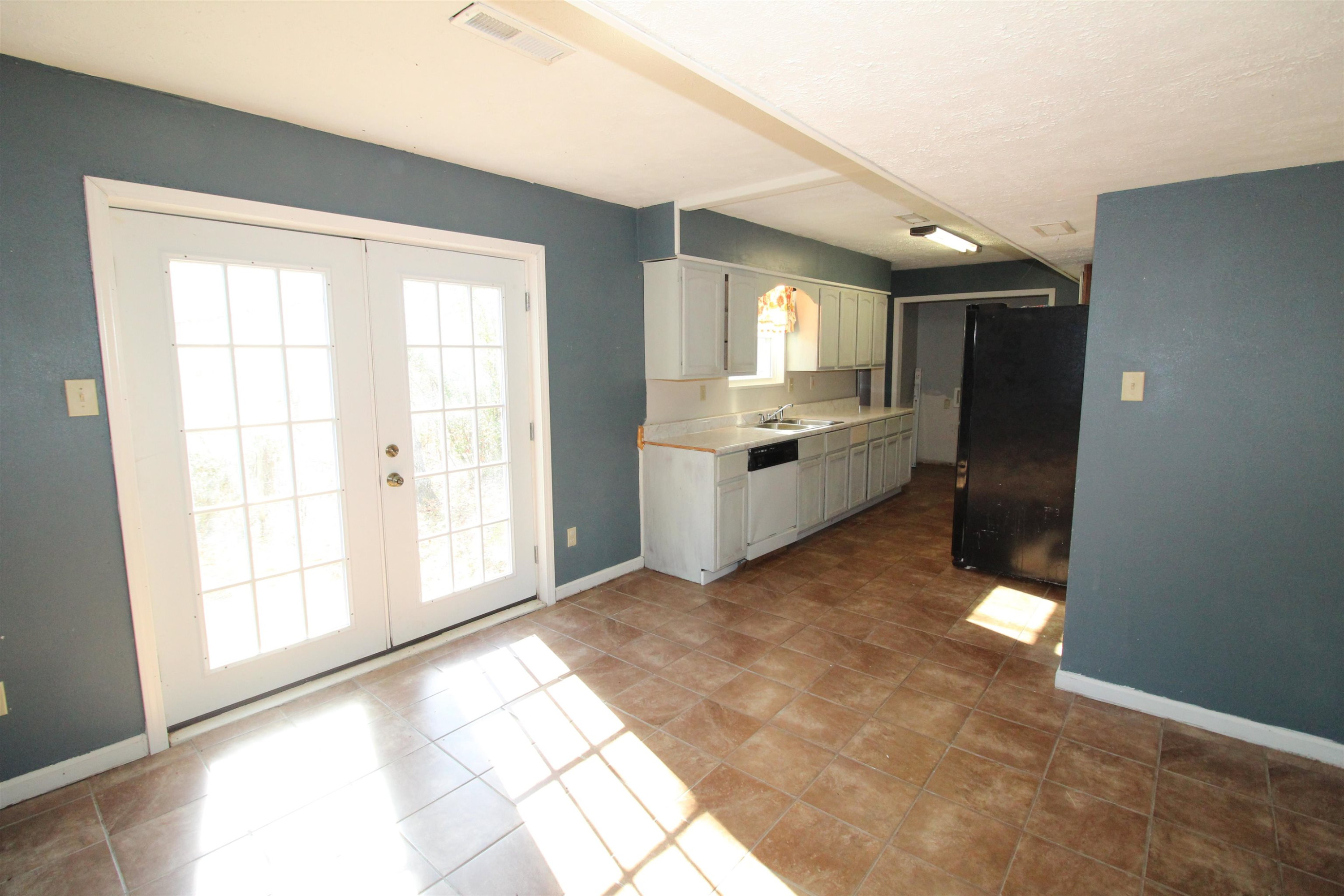 410 Lowery Road Medon, TN 38356 - Photo 5 of 24 a view of an empty room with a fireplace and a window