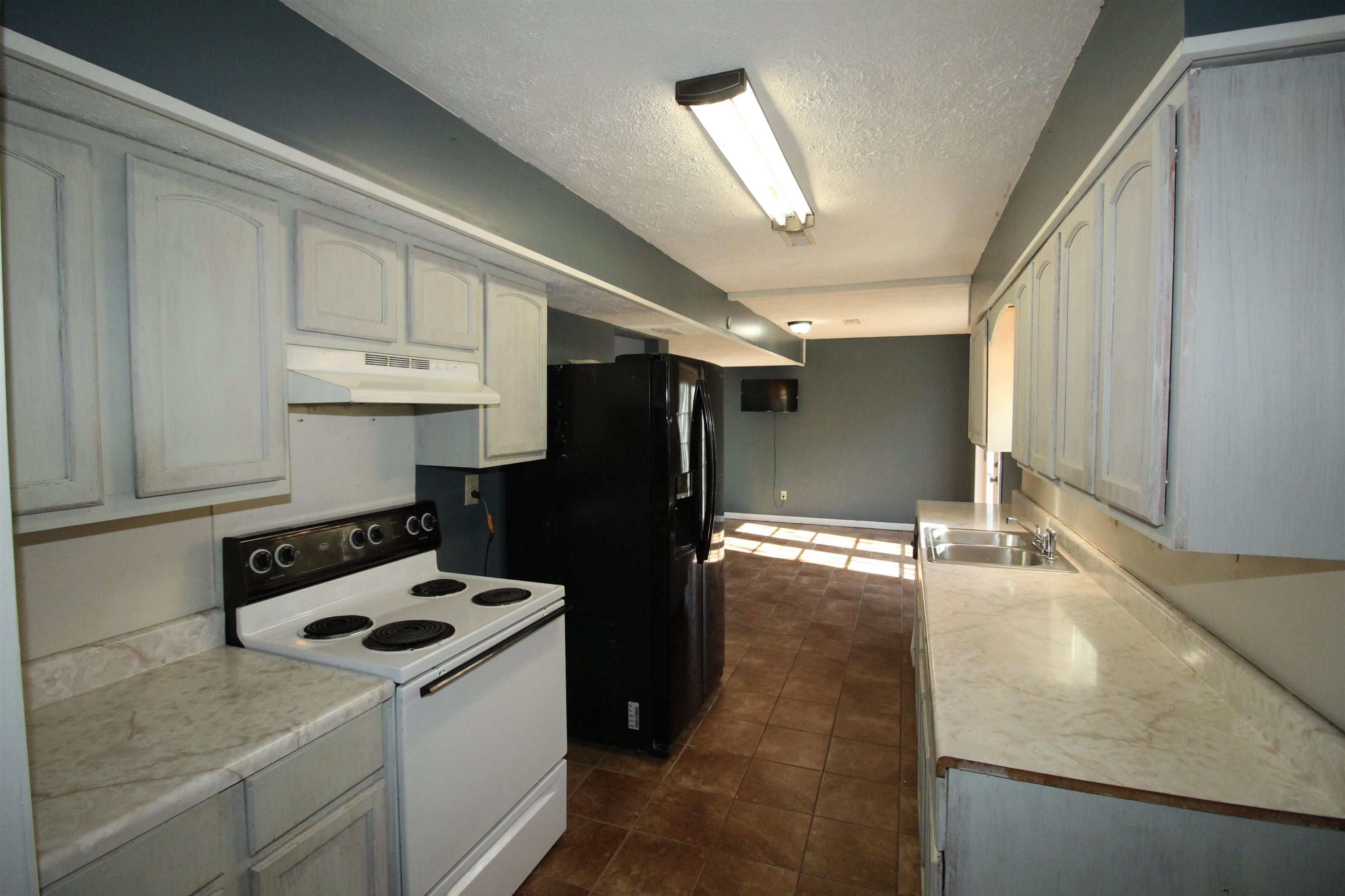 410 Lowery Road Medon, TN 38356 - Photo 8 of 24 a kitchen with a stove a refrigerator and cabinets