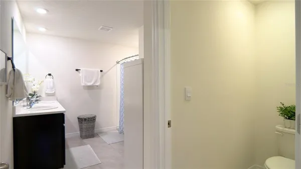 a bathroom with a sink vanity and a mirror