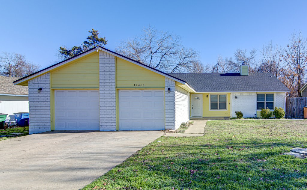 12413 Turtle Rock Road Austin, TX 78729 - Photo 1 of 1 a front view of a house with a yard and garage