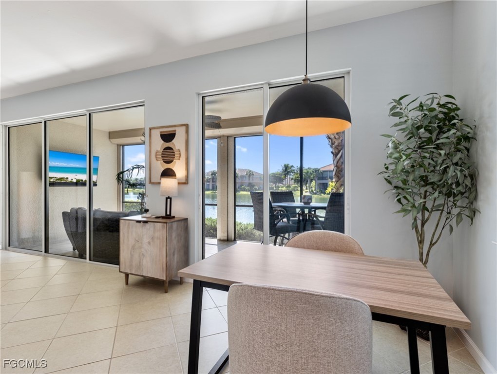 10260 Glastonbury Circle, Unit 102 Fort Myers, FL 33913 - Photo 12 of 44 a dining room with furniture and chandelier