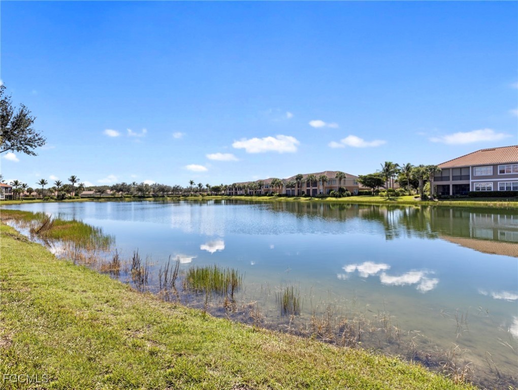 10260 Glastonbury Circle, Unit 102 Fort Myers, FL 33913 - Photo 15 of 44 a view of a lake with houses in the back
