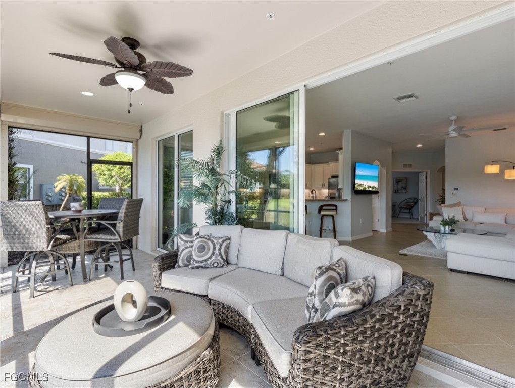 10260 Glastonbury Circle, Unit 102 Fort Myers, FL 33913 - Photo 16 of 44 a living room with furniture and a large window