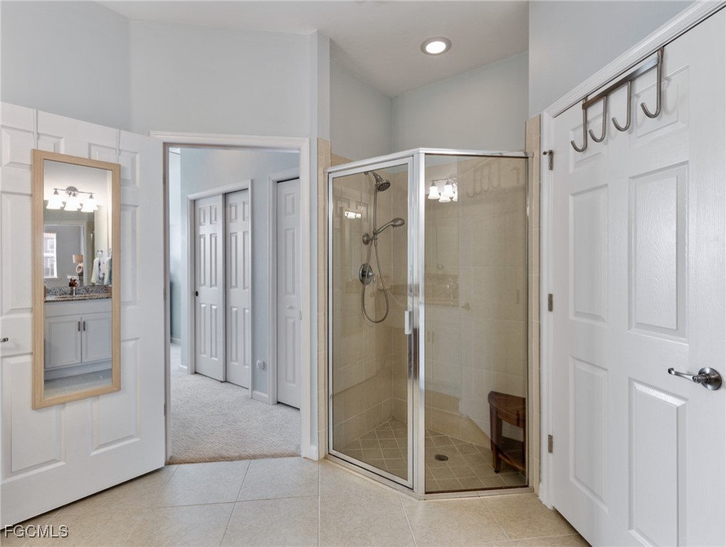10260 Glastonbury Circle, Unit 102 Fort Myers, FL 33913 - Photo 27 of 44 a bathroom with a glass shower door and a sink