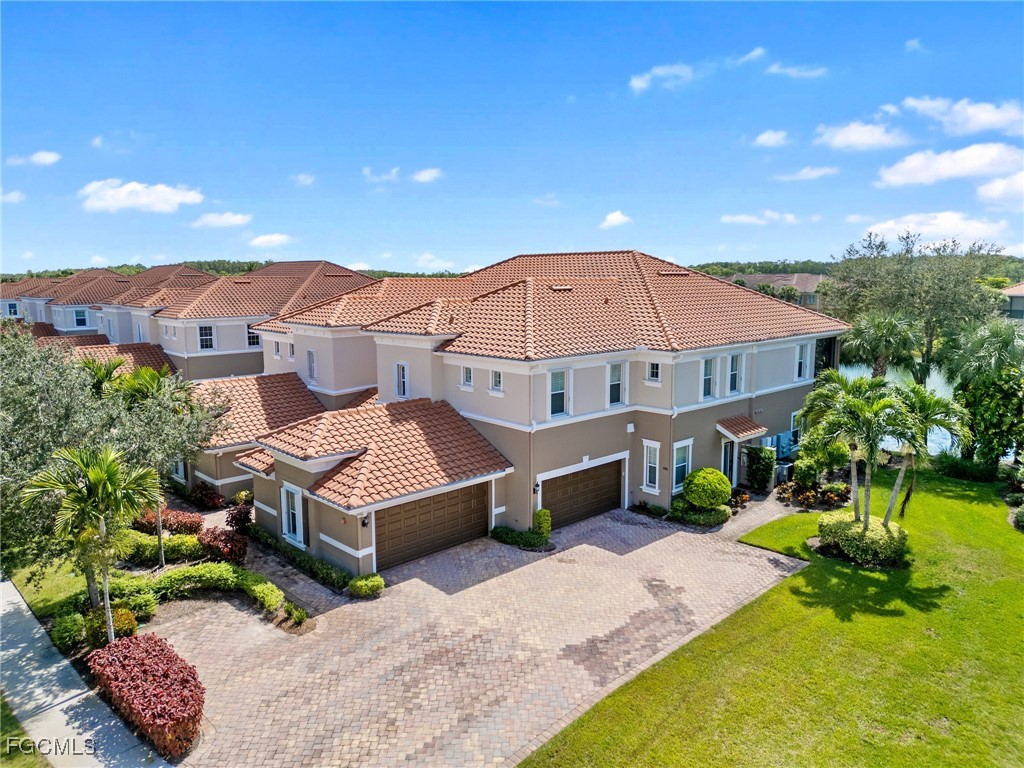 10260 Glastonbury Circle, Unit 102 Fort Myers, FL 33913 - Photo 34 of 44 a view of a house with a yard and sitting area