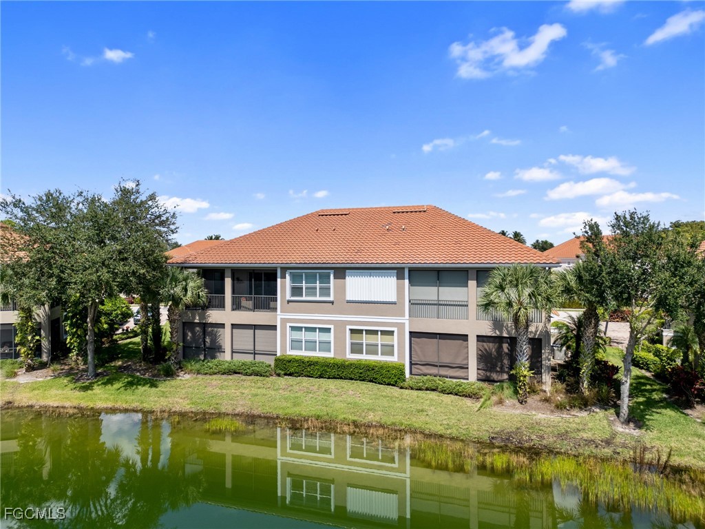 10260 Glastonbury Circle, Unit 102 Fort Myers, FL 33913 - Photo 37 of 44 a view of a house with a yard table and chairs