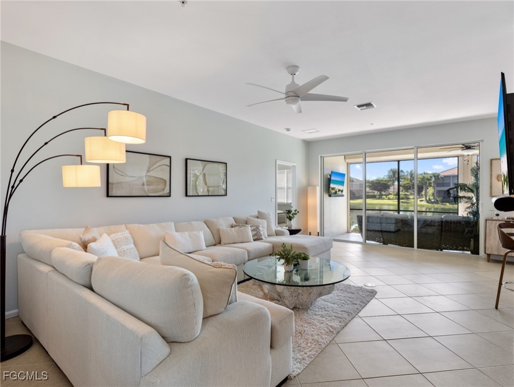 10260 Glastonbury Circle, Unit 102 Fort Myers, FL 33913 - Photo 5 of 44 a living room with furniture and a table