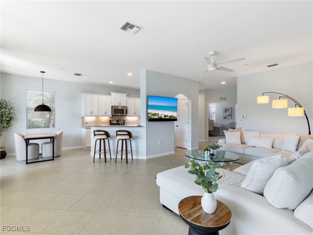 10260 Glastonbury Circle, Unit 102 Fort Myers, FL 33913 - Photo 8 of 44 a living room with furniture and kitchen view