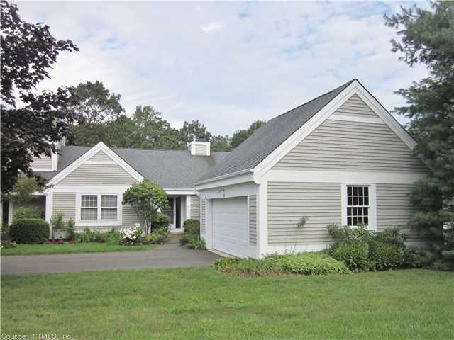111 Legend Hill Road, Unit 111 Madison, CT 06443 - Photo 1 of 1 a front view of a house with a garden