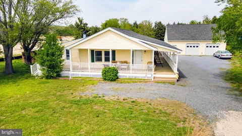 an aerial view of a house with swimming pool and wooden fence
