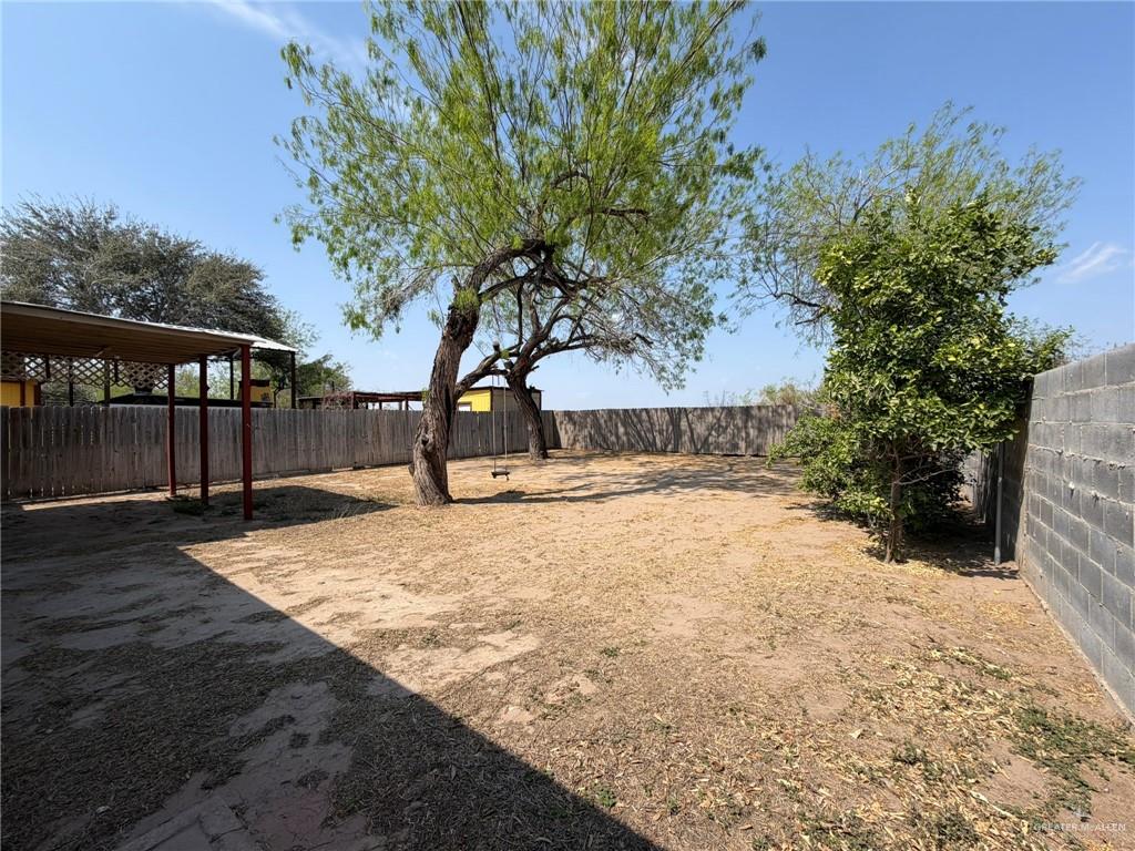 1814 Canyon Street Rio Grande City, TX 78582 - Photo 7 of 9 a view of a yard with plants and trees