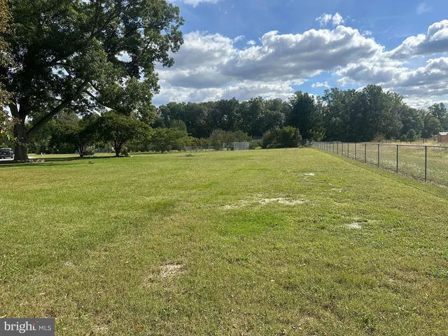 a view of grassy field with trees