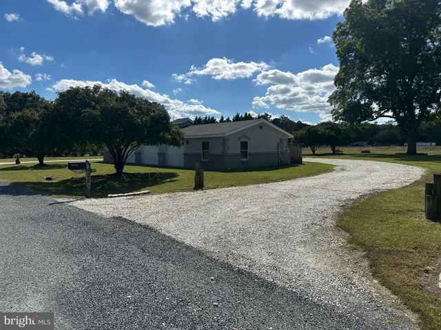 a view of a large yard with a house in the background