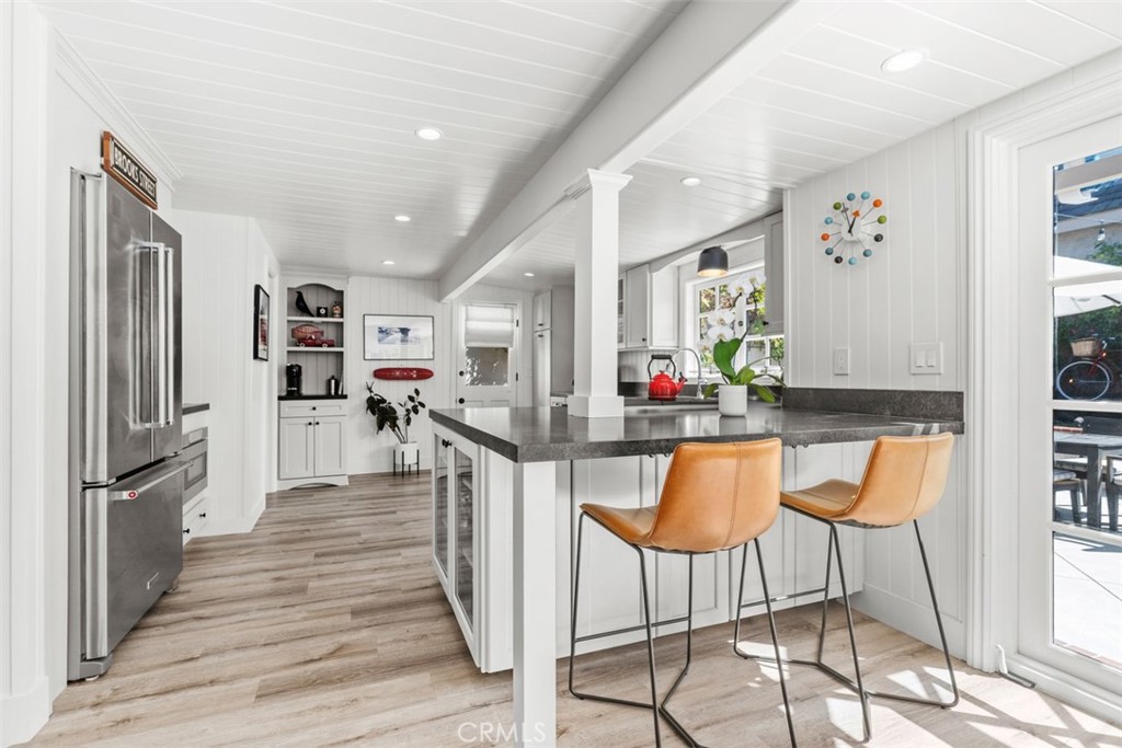 455 Brooks Street Laguna Beach, CA 92651 - Photo 11 of 32 a kitchen with stainless steel appliances kitchen island granite countertop a refrigerator and microwave