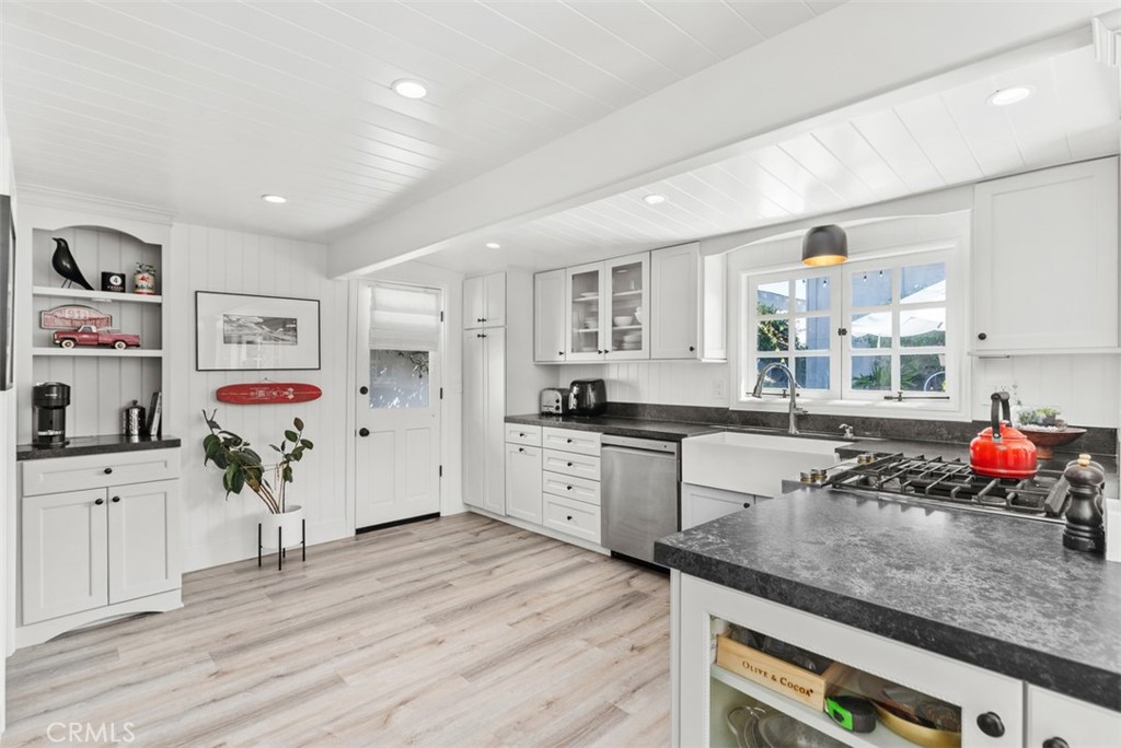 455 Brooks Street Laguna Beach, CA 92651 - Photo 12 of 32 a kitchen with granite countertop a sink stainless steel appliances and cabinets