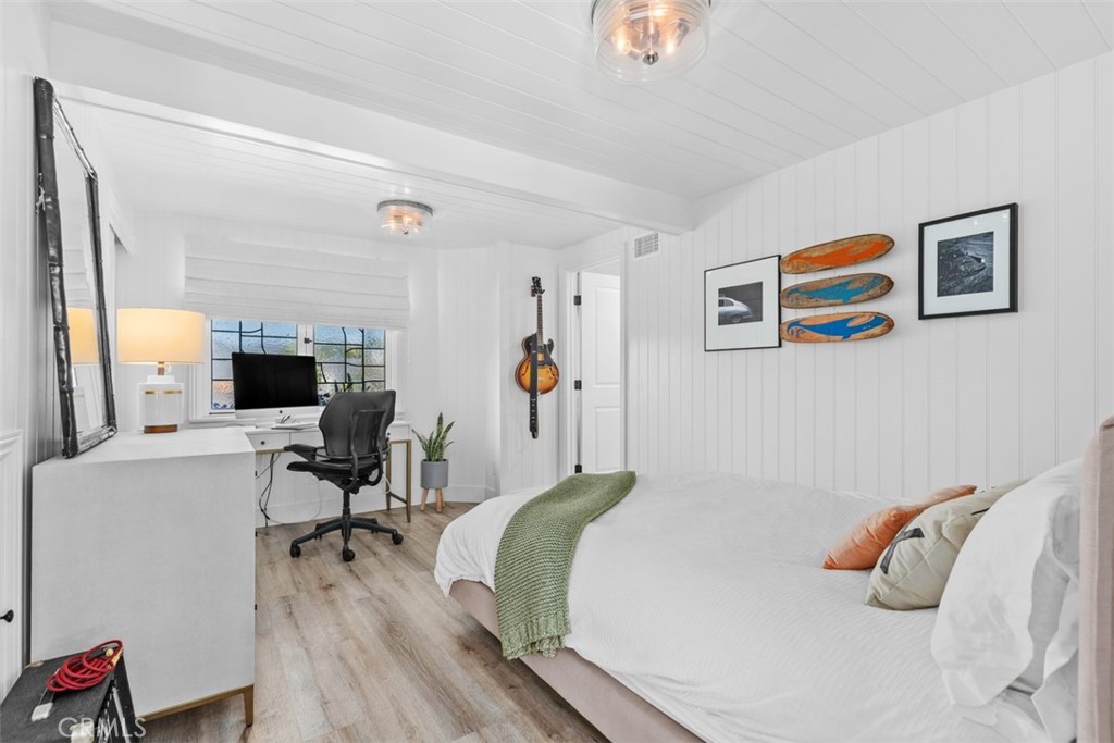 455 Brooks Street Laguna Beach, CA 92651 - Photo 16 of 32 a bedroom with a bed and a workspace