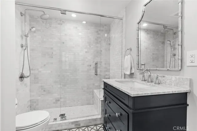 a bathroom with a sink shower and a mirror