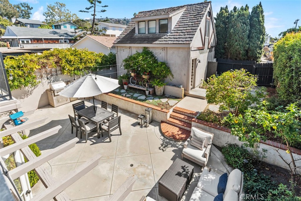 455 Brooks Street Laguna Beach, CA 92651 - Photo 26 of 32 a view of a patio with table and chairs potted plants