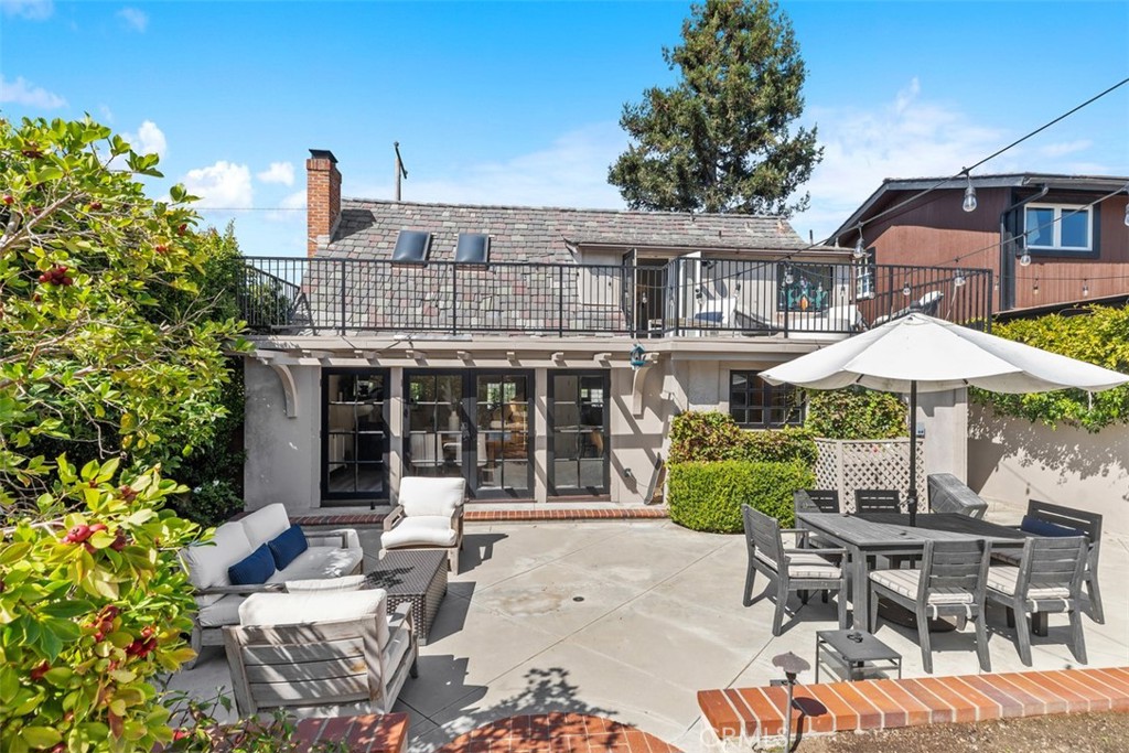455 Brooks Street Laguna Beach, CA 92651 - Photo 30 of 32 a patio with a table and chairs under an umbrella