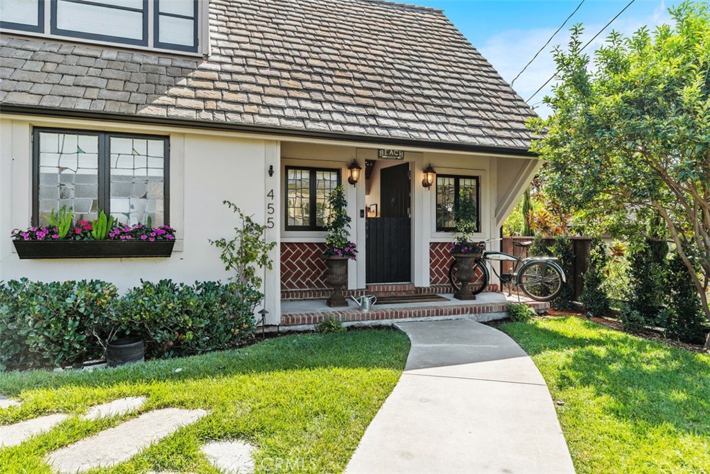 455 Brooks Street Laguna Beach, CA 92651 - Photo 3 of 32 a front view of a house with a yard and potted plants