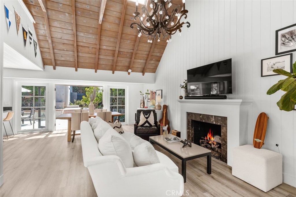 455 Brooks Street Laguna Beach, CA 92651 - Photo 5 of 32 a living room with furniture a flat screen tv and a fireplace