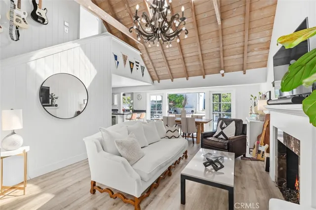 a living room with fireplace furniture and a large window