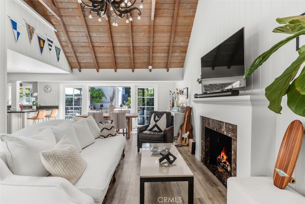 455 Brooks Street Laguna Beach, CA 92651 - Photo 8 of 32 a living room with furniture a fireplace a flat screen tv and a large window