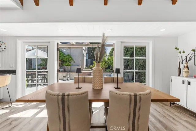 a dining room with furniture and large windows