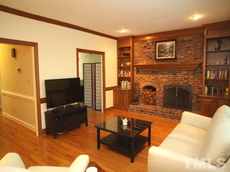 1205 Stone Creek Way Raleigh, NC 27615 - Photo 3 of 13 Grand Masonry Fireplace is the focal point of this light filled Family Room.