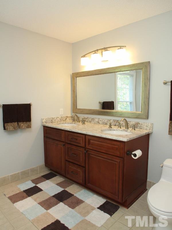 1205 Stone Creek Way Raleigh, NC 27615 - Photo 8 of 13 Upgraded lights, cabinets and GRANITE plus tile floor in here! Two WICS!!