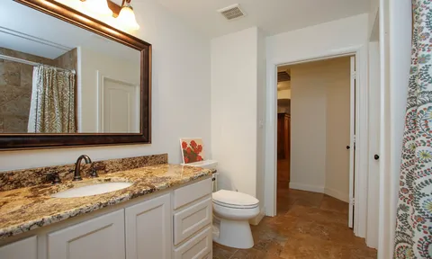 a bedroom with a bed a desk and chair