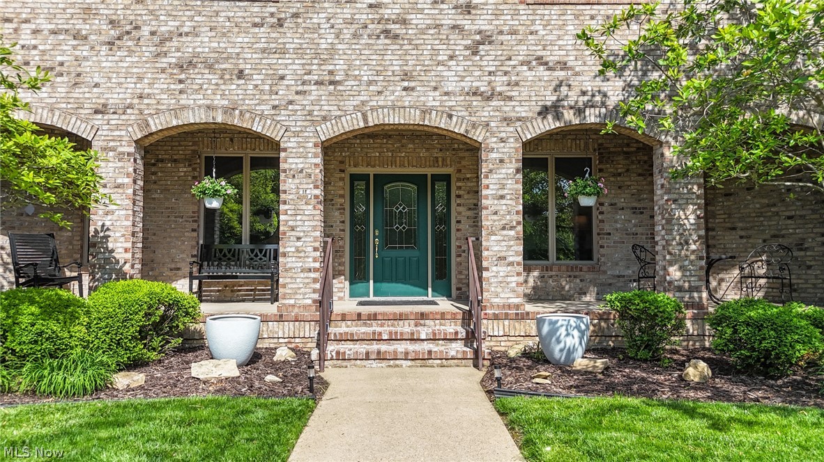 1602 Glendale Road, Unit 3 Marietta, OH 45750 - Photo 3 of 49 Brick exterior with a prominent green entry door featuring decorative glass