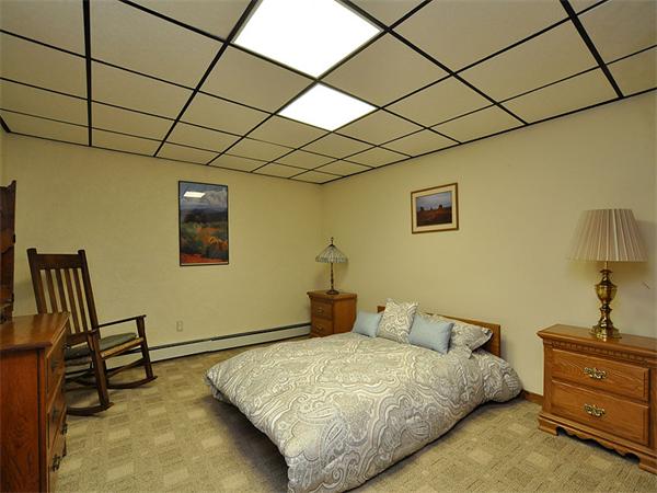112 Prescott Road Boxborough, MA 01719 - Photo 23 of 30 a bedroom with a bed and a chandelier