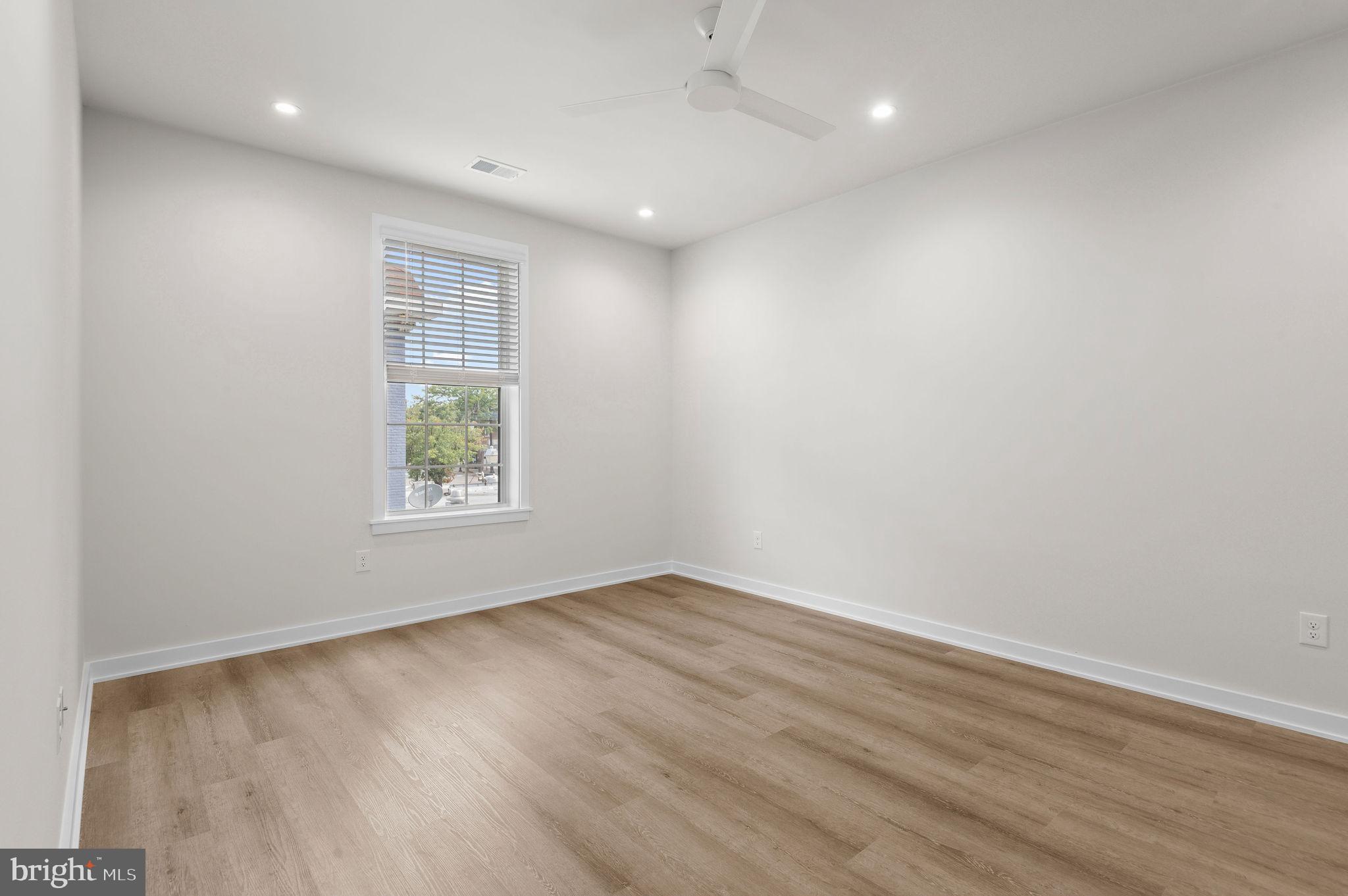 26 South York Road, Unit 408 Hatboro, PA 19040 - Photo 17 of 52 an empty room with wooden floor and windows