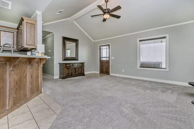 a view of an empty room with a fireplace and a window