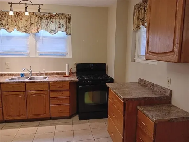 a kitchen with cabinets and window