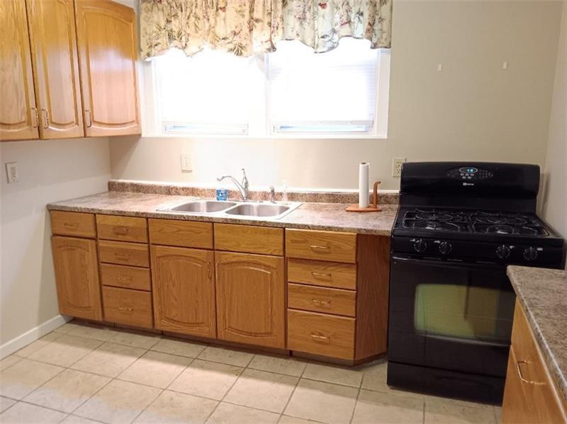6501 Deary Street Pittsburgh, PA 15206 - Photo 12 of 47 a kitchen with cabinets and window