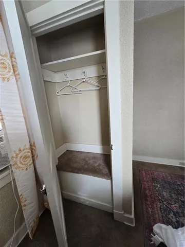 en empty room with wooden floor and stairs