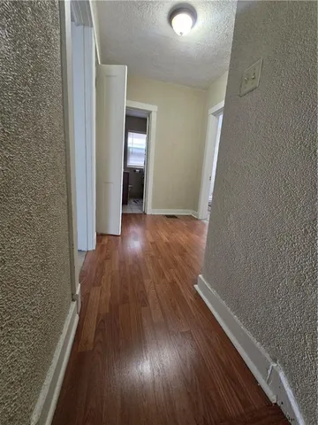 a bed sitting in a room next to a window